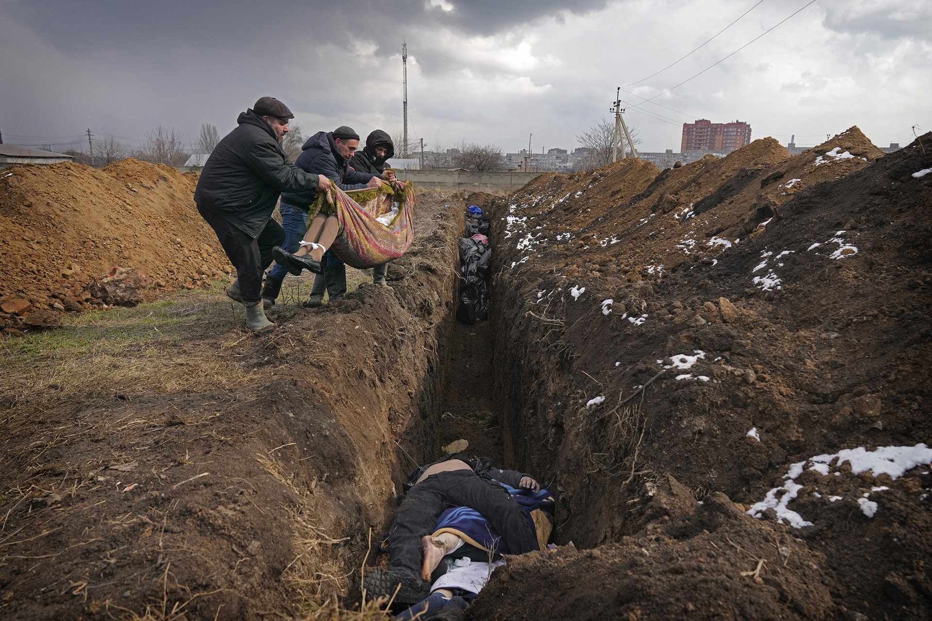 People place dead bodies in a mass grave in an old cemetery in Mariupol, Ukraine. According to the BBC, on some days, up to 150 people a day were buried in mass graves during periods of heavy Russian shelling.